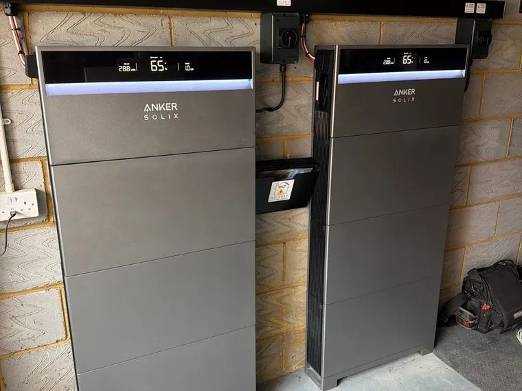 Two Anker SOLIX X1 battery towers installed at ground level in a garage