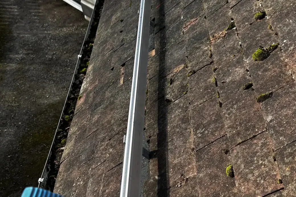 Mounting rail running across a tiled roof before the panels were fitted
