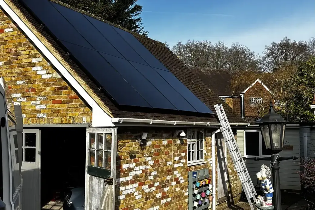 Completed all-black AIKO array on a clay-tiled roof