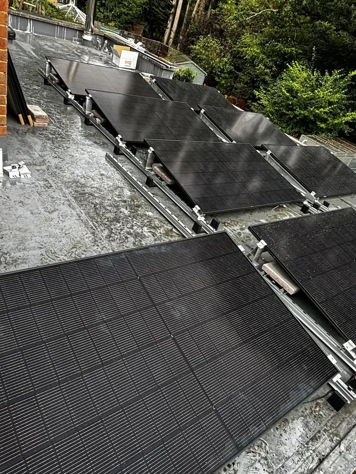 Canadian Solar panels being positioned on flat-roof mounting frames