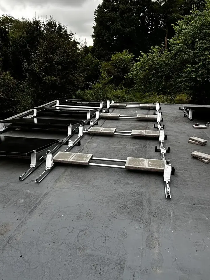 Flat-roof mounting frames installed before the Canadian Solar panels